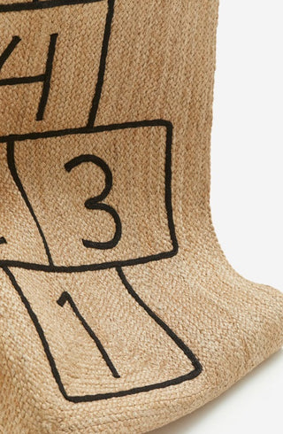Braided jute rug with an embroidered hopscotch motif